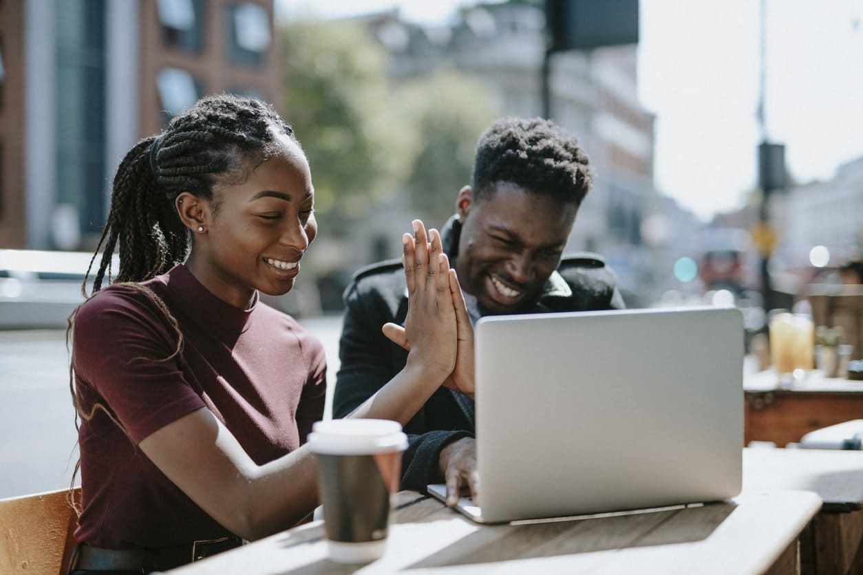 man and woman shopping for dental insurance on laptop