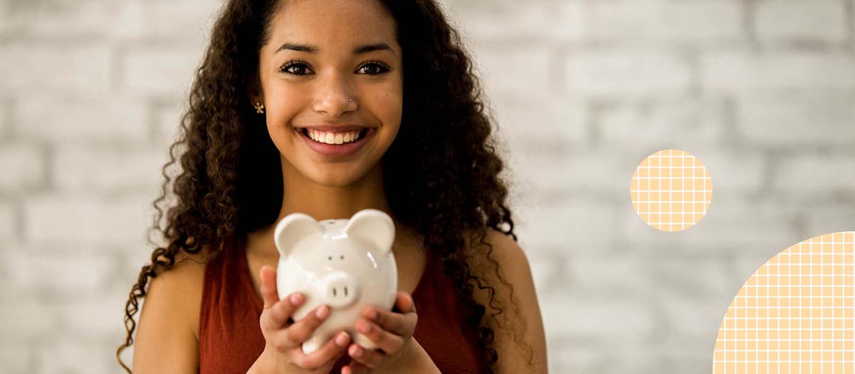 Young woman holding a piggy bank
