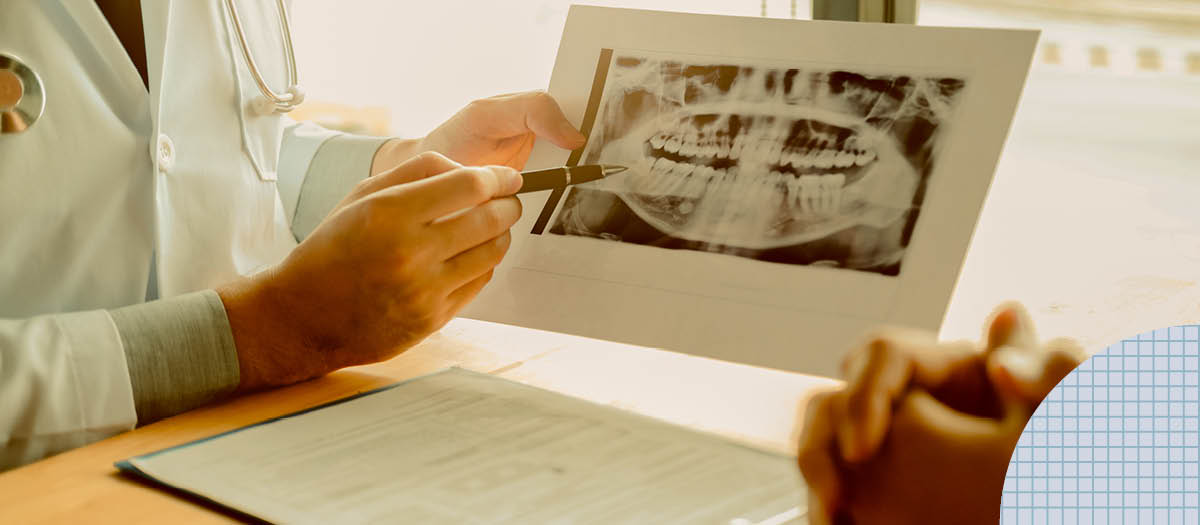 Doctor showing patient x-ray of their mouth 